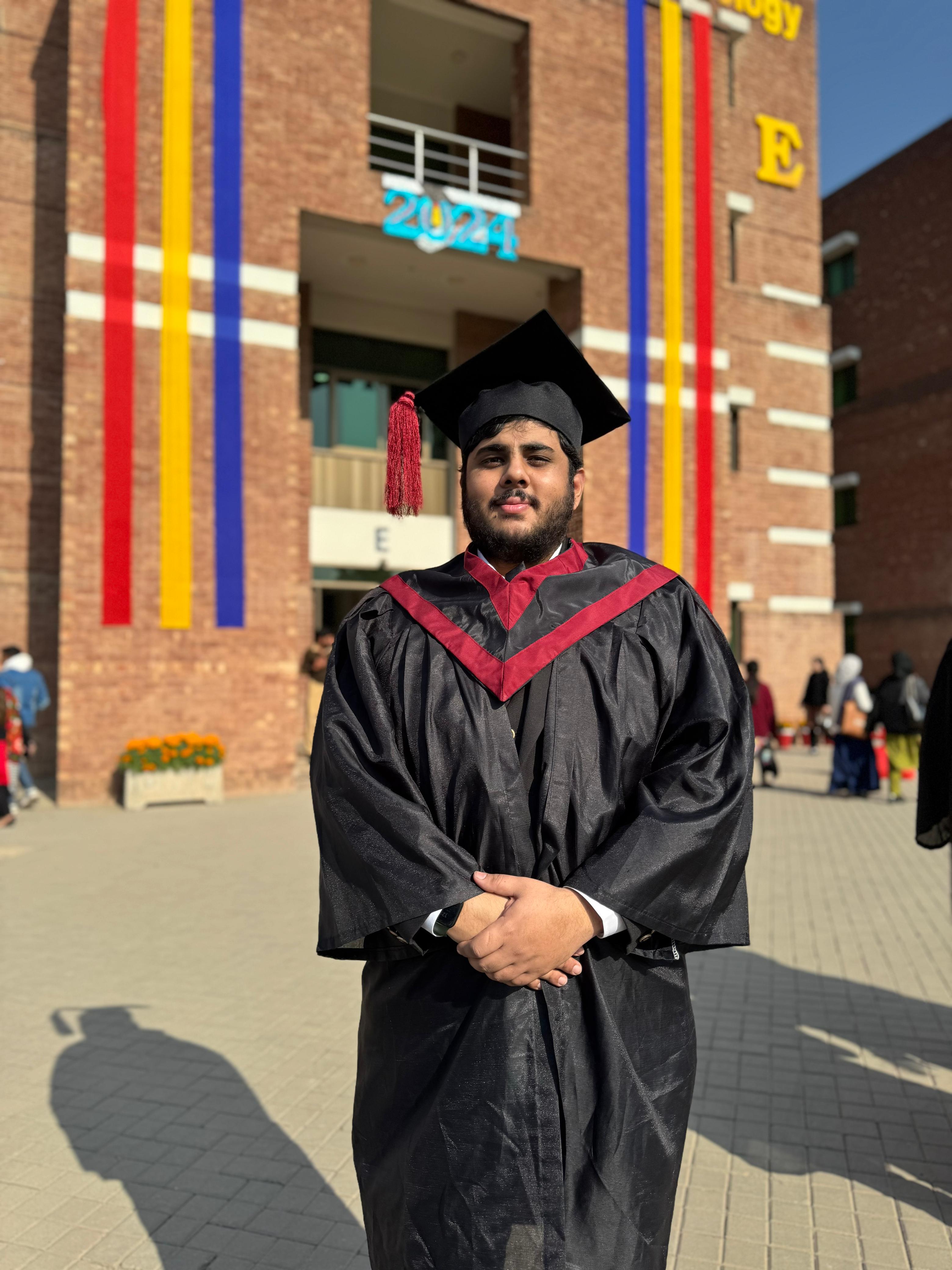 Ibne Shukran in a graduation cap and gown at CUST