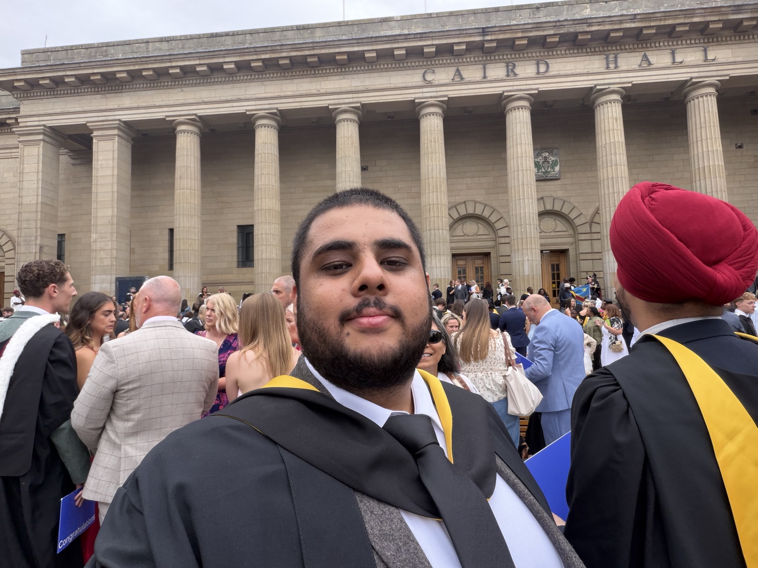 Ibne Shukran taking a graduation selfie outside Caird Hall